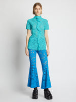 Front image of model wearing Stretch Lace Top in cyan