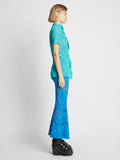 Side image of model wearing Stretch Lace Top in cyan