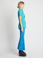 Side image of model wearing Stretch Lace Top in cyan