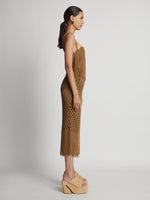 Side image of model wearing Lacquered Knit Dress in tobacco