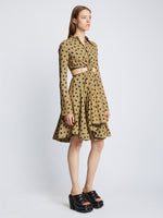 Side image of model wearing Printed Dot Cut Out Shirt Dress in khaki black