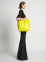 Image of model wearing Drawstring Tote in CANARY YELLOW