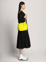 Image of model wearing Drawstring Pouch in CANARY YELLOW
