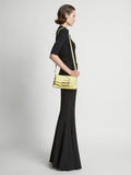 Image of model carrying Small Bar Bag in LEMONGRASS