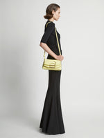 Image of model carrying Small Bar Bag in LEMONGRASS