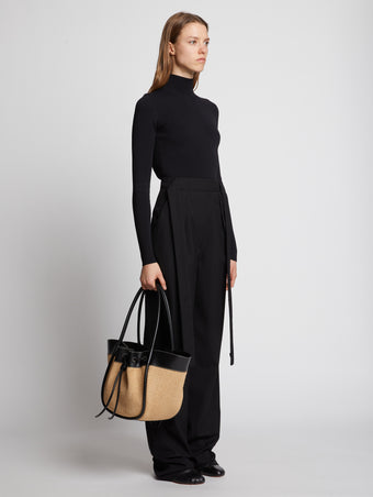 Image of model carrying Raffia Large Ruched Tote in BLACK/SAND