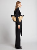 Image of model carrying Raffia Large Ruched Tote in BLACK/SAND