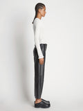 Side image of model wearing Cropped Turtleneck Chenille Sweater in off white