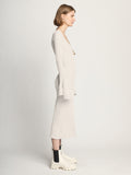 Side image of model wearing Fluted Rib Knit Dress in ivory