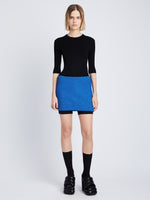 Front image of model wearing Boucle Tweed Skirt in turquoise