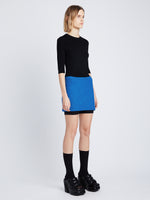 Side image of model wearing Boucle Tweed Skirt in turquoise