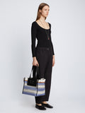 Image of model carrying Large Morris Stripe Canvas Tote in BLACK/WHITE/COBALT in hand
