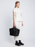 Image of model carrying Large Morris Raffia Tote in BLACK in hand