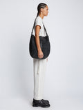 Image of model carrying Sullivan Raffia Bag in BLACK on shoulder
