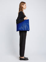 Image of model carrying Twin Nappa Tote in COBALT on shoulder