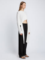 Side full length image of model wearing Ribbed Cotton Wrap Sweater in OFF WHITE