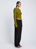 Side full length image of model wearing Ribbed Cotton Wrap Sweater in LEAF