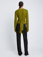 Back full length image of model wearing Ribbed Cotton Wrap Sweater in LEAF