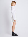 Side full length image of model wearing Tweed Wrap Skirt in OFF WHITE