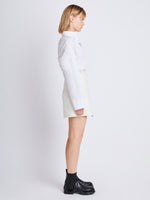 Side full length image of model wearing Tweed Wrap Skirt in OFF WHITE