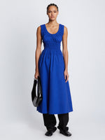 Front full length image of model wearing Poplin Gathered Dress in ROYAL BLUE styled over black Viscose Suiting Pants