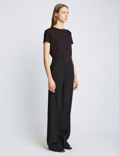 Side full length image of model wearing Short Sleeve T-Shirt in BLACK