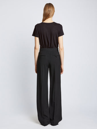 Back full length image of model wearing Short Sleeve T-Shirt in BLACK