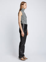 Side full length image of model wearing Slinky Jersey Turtleneck Top in BLACK/WHITE/JADE