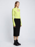 Side full length image of model wearing Long Sleeve Jersey Keyhole Top in LIME