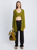 Front full length image of model wearing Ribbed Cotton Relaxed Cardigan in LEAF with belt removed