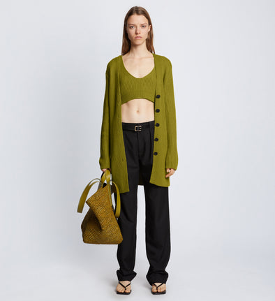Front full length image of model wearing Ribbed Cotton Relaxed Cardigan in LEAF with belt removed