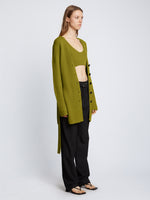 Side full length image of model wearing Ribbed Cotton Relaxed Cardigan in LEAF 