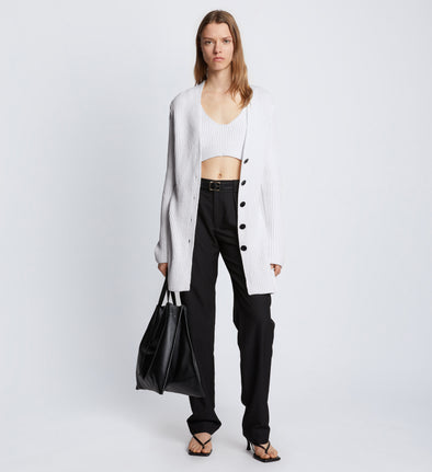 Front full length image of model wearing Ribbed Cotton Relaxed Cardigan in OFF WHITE with belt removed