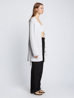 Side full length image of model wearing Ribbed Cotton Relaxed Cardigan in OFF WHITE