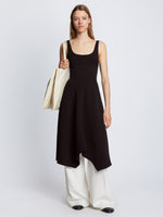 Front full length image of model wearing Barre Bustier Dress in BLACK styled with white pants