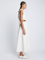 Side full length image of model wearing Poplin Cut Out Midi Dress in OFF WHITE