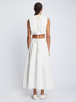 Back full length image of model wearing Poplin Cut Out Midi Dress in OFF WHITE