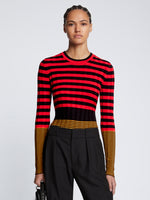 Front cropped image of model wearing Slinky Stripe Long Sleeve Sweater in CHERRY/GOLDEN ROD/BLACK