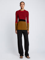 Front full length image of model wearing Slinky Stripe Long Sleeve Sweater in CHERRY/GOLDEN ROD/BLACK untucked