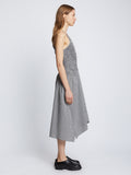 Side full length image of model wearing Gingham Seersucker Smocked Dress in OFF WHITE/BLACK
