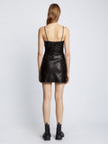 Back full length image of model wearing Faux Leather Ruched Mini Dress in BLACK