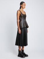 Side full length image of model wearing Faux Leather Bustier Top in BLACK
