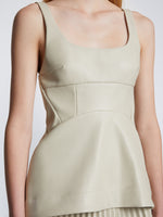 Detail image of model wearing Faux Leather Bustier Top in CHALK