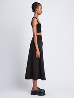 Side full length image of model wearing Soft Poplin Wrap Skirt in BLACK