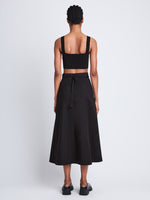 Back full length image of model wearing Soft Poplin Wrap Skirt in BLACK