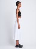 Side full length image of model wearing Soft Poplin Wrap Skirt in OFF WHITE