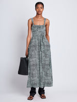 Front full length image of model wearing Viscose Flou Wrap Dress in BLACK/PAPER MINT with belt tied in front, styled over black Viscose Suiting Pants