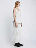 Side full length image of model wearing Poplin Gathered Tank Top in OFF WHITE