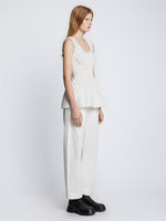 Side full length image of model wearing Poplin Gathered Tank Top in OFF WHITE
