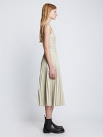 Side full length image of model wearing Faux Leather Pleated Skirt in CHALK